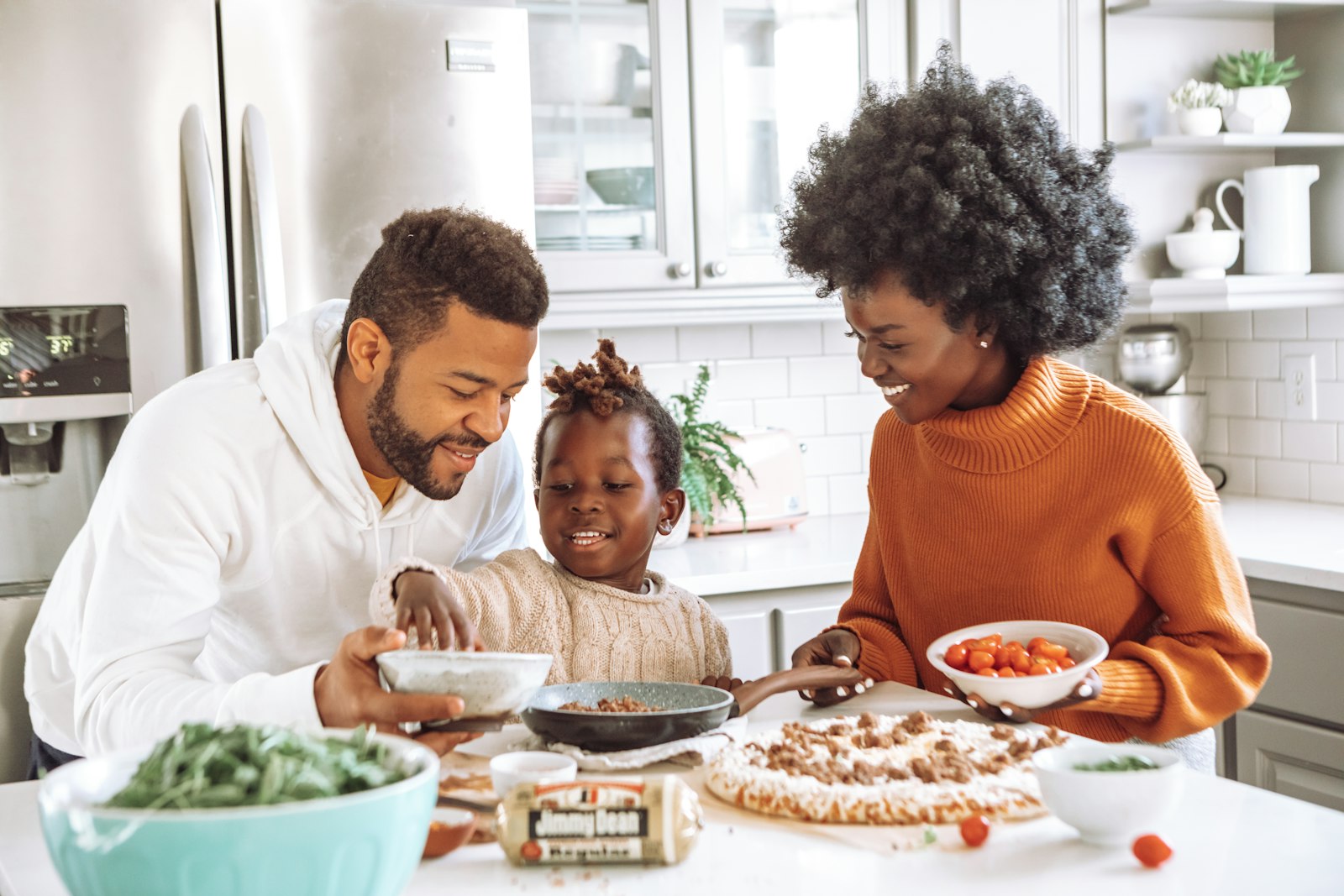 A family cooking together in a bright kitchen