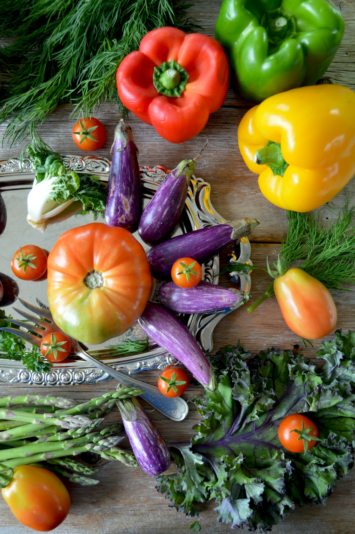 A colorful flat lay of fresh vegetables and herbs
